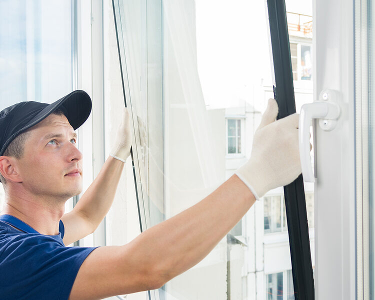 master puts a new double-glazed window in a plastic window